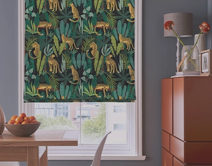 A range of patterned roman blinds including bold floral prints, charming children's designs...