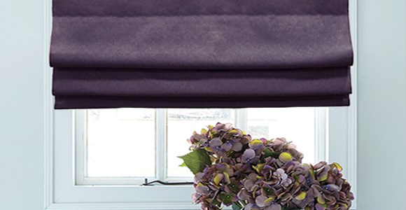 A lovely selection of purple roman blinds in a variety of shades and textures